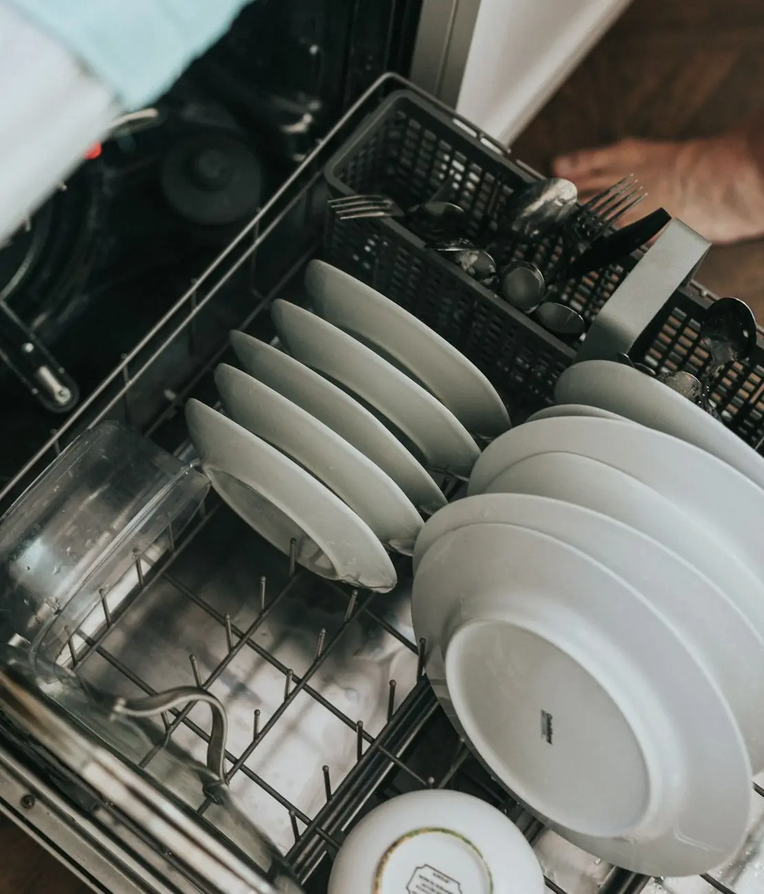 white ceramic plate on black dishwasher
